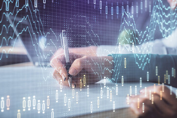 Double exposure of forex chart drawing over people taking notes background. Concept of financial...