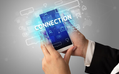 Female hand typing on smartphone with CONNECTION inscription, social media concept