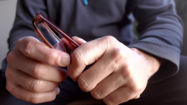 Man fumbling with reading glasses