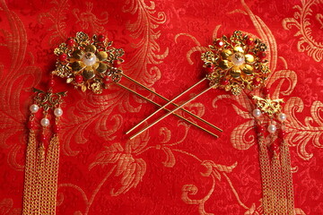Chinese traditional wedding women's jewelry hairpins. still-life jn a red background