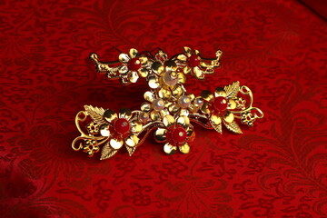 Chinese traditional wedding women's jewelry hairpins. still-life jn a red background