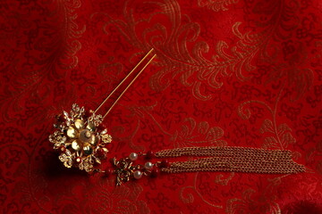 Chinese traditional wedding women's jewelry hairpins. still-life jn a red background