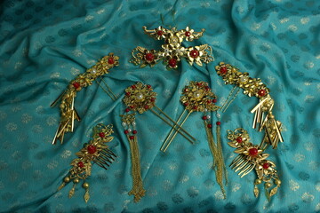 Chinese traditional hairpins hair clips Traditional Chinese women's jewelry. Gold hairpins with red gems. blue background