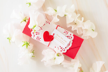 Gift box with red heart and white sweet peas
