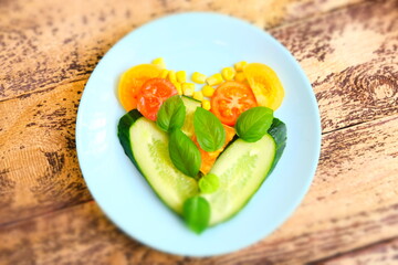 Healthy salad simple ingredients with vegetables in heart shape. tomatoes, cucumbers, basil, corn. fibre antioxidants, minerals and vitamins. Shallow DOF. Selective focus Very light breakfast concept