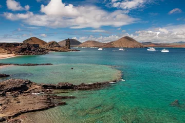 Foto op Canvas Galapagos islands. Ecuador. Volcanic Pinnacle Rock next to underwater crater and sandy beach on Bartolome island. Travelling to Galapagos Islands National Park. Popular tourist attraction. © Nikolai