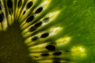 Macro shot of a slice of ripe green kiwi © Ingo Heddinga/Wirestock