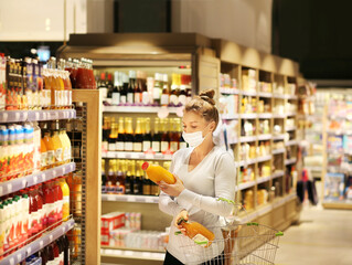 supermarket shopping, face mask and gloves,Woman choosing a dairy products at supermarket