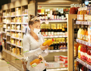 supermarket shopping, face mask and gloves,Woman choosing a dairy products at supermarket