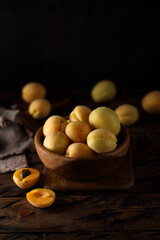 Fototapeta na wymiar Fresh ripe apricots in a wooden bowl
