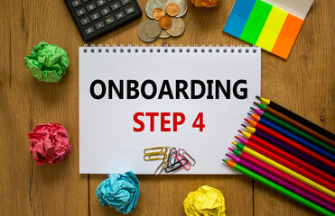 Onboarding symbol. White note with a word 'onboarding step 4' on beautiful wooden table, colored paper, colored pencils, paper clips, coins and calculator. Business and onboarding step 4 concept.