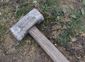 the sledgehammer lies on the grass
