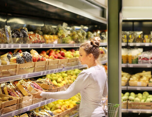 Woman buying fruits and vegetables at the market.