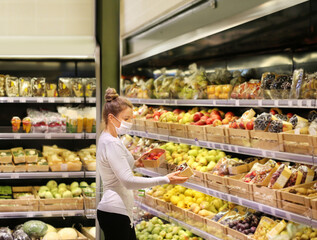 Supermarket shopping, face mask and gloves,Woman buying fruits at the market.