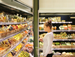 Woman buying fruits and vegetables at the market.