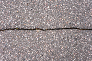 Old worn and cracked asphalt with crack, copy space