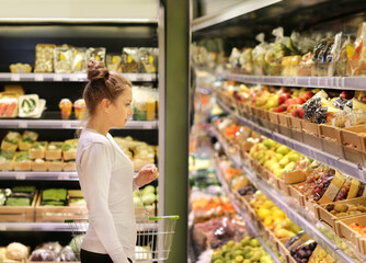 Woman buying fruits and vegetables at the market.