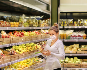Supermarket shopping, face mask and gloves,Woman buying fruits at the market.