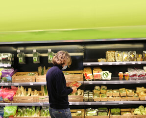 Supermarket shopping, face mask and gloves,man buying vegetables at the market.