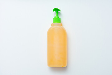 Bottle of gel or liquid soap dispenser with plastic pump, white background, copy space