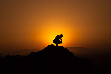 Obraz na płótnie Canvas silhouette of a man watching the sunset