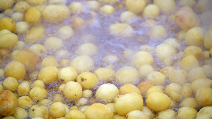young potatoes are fried in boiling oil