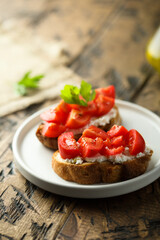 Homemade bruschetta with cream cheese and tomato