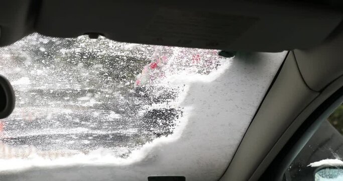 Woman Scraping Windshield, Woman removing snow from a Car, Lady removing snow from windshield with snow brush