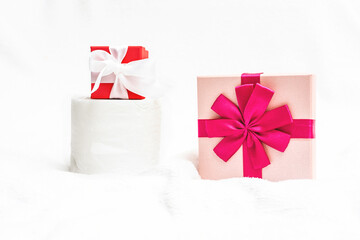 Toilet paper, two gifts for New year on a white background, artificial snow, copy space