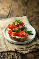 Homemade bruschetta with cream cheese and tomato