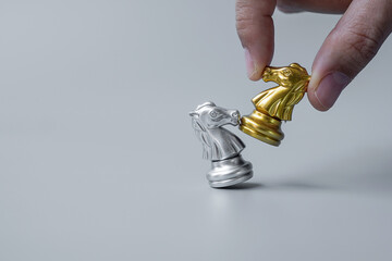 businessman hand moving gold Chess Knight (horse) ``figure and Checkmate enermy or opponent during...