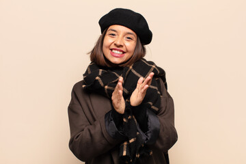 hispanic woman feeling happy and successful, smiling and clapping hands, saying congratulations...