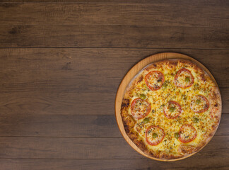 ricardo fernando franca junior pizza mussarela muçarela mucarelTasty mozzarella cheese pizza with slices of red tomatoes on a wooden board. Horizontal top photograph Space for texts.