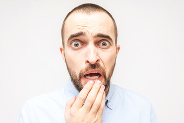 Bearded afraid, portrait of scared young man, white background, closeup