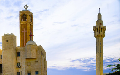 Jordan, Amman, Minaret of the mosque King Abdullah and in front a christian church tower.