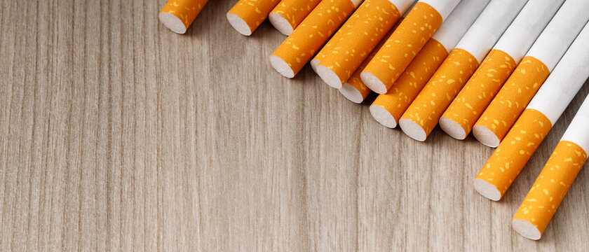 cigarettes. pile on wooden background. image of several commercially made or Non smoking campaign concept, tobacco.
