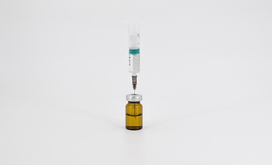 Syringe and vaccine in a bottle