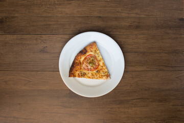 ricardo fernando franca junior pizza mussarela muçarela mucarelA slice of mozzarella cheese pizza with slices of red tomatoes, served on a plate. Top shot with centralized food.