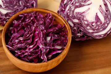 vegetable of fresh cabbage purple and cutted slices in bowl on wooden cutting board background,...