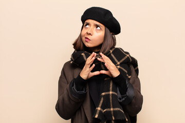 hispanic woman scheming and conspiring, thinking devious tricks and cheats, cunning and betraying
