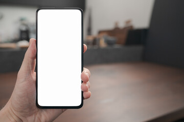 Man hand hold phone with white screen over black walnut table background