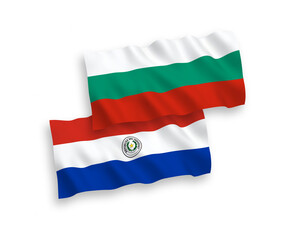 National vector fabric wave flags of Bulgaria and Paraguay isolated on white background. 1 to 2 proportion.