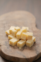 Pieces of hard vintage cheese on wood olive board