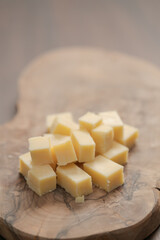 Pieces of hard vintage cheese on wood olive board