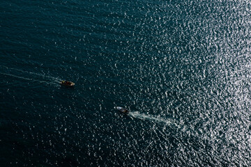 two boats driving in the open sea