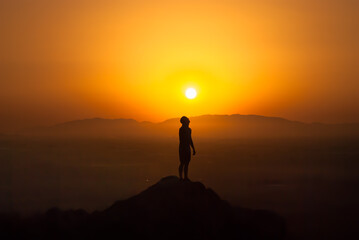 silhouette of a man looking sun