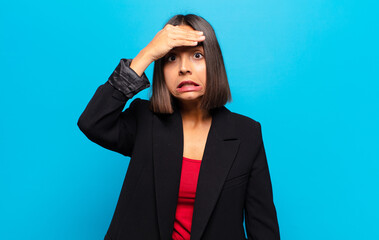 hispanic woman panicking over a forgotten deadline, feeling stressed, having to cover up a mess or...