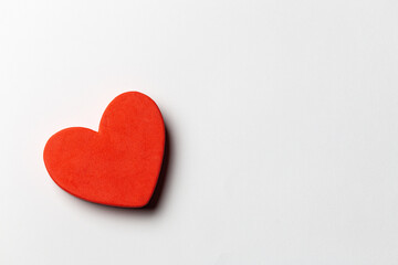 Red heart shapes over white paper background