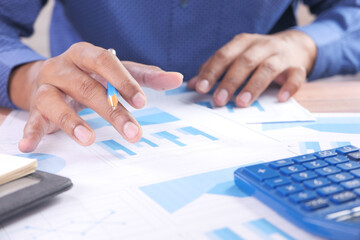 young man working on office table analyzing financial data 