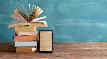 Stack of books and an e-book reader. E- Book, book fair,reading,realaxing,education concept. Free...